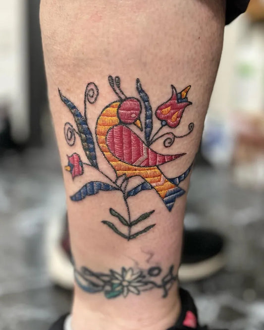 Medium Embroidery Bird and Flowers Tattoo on Women Ankle by @ailurophile_tattoos