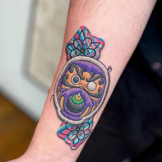 Medium Embroidery Daruma Mask with Flowers Tattoo on Men Arm by @authentink_studio