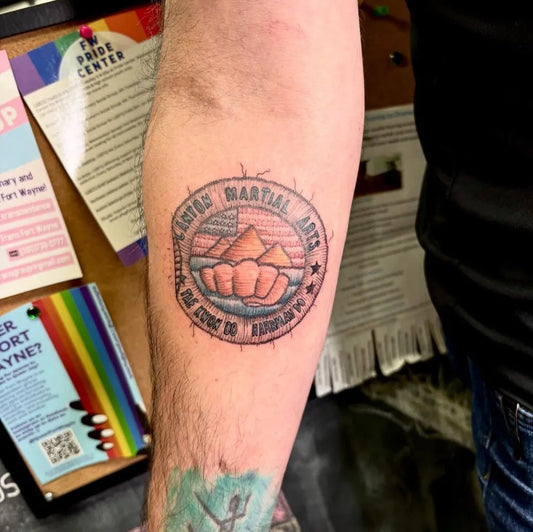 Medium Embroidery Martial Arts Circle with Mountains and Fist Tattoo on Men Arm by @thedancingoctopus