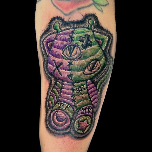Medium Embroidery Purple Green Frankenstein Teddy Bear Tattoo on Women Arm by @tattoosbyraychill