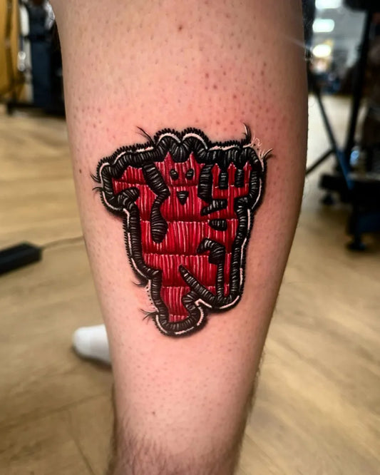 Medium Embroidery RedDevilCrest Tattoo on Men Leg by @_richmccann