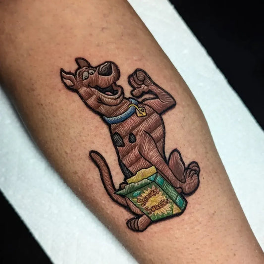 Medium Embroidery Scooby Doo Holding Scooby Snacks Tattoo on Men Arm by @laurenyoungtattoos