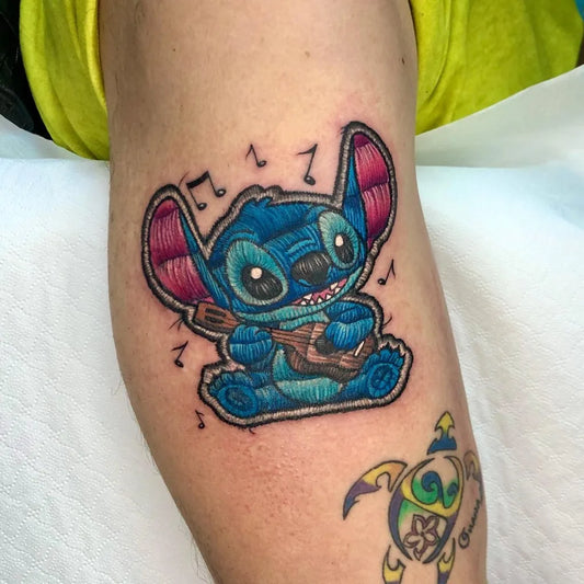 Medium Embroidery Stitch with Ukulele Tattoo on Women Arm by @alessiabikinibottom
