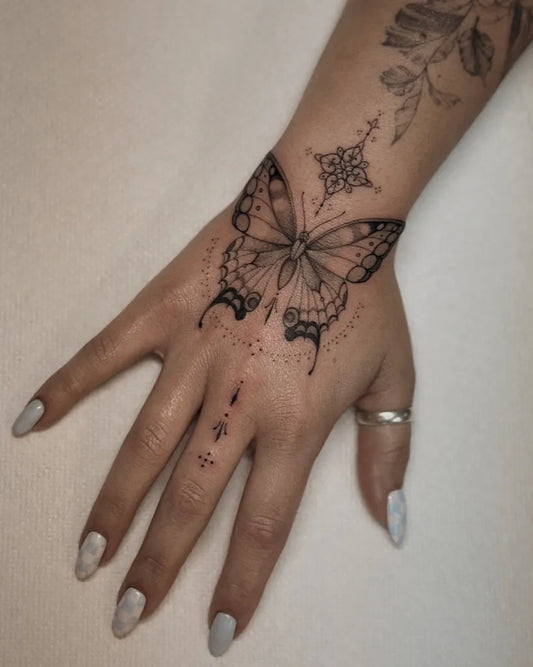 Fine Line Butterfly on Women Hand Tattoo by @mercurial_ink