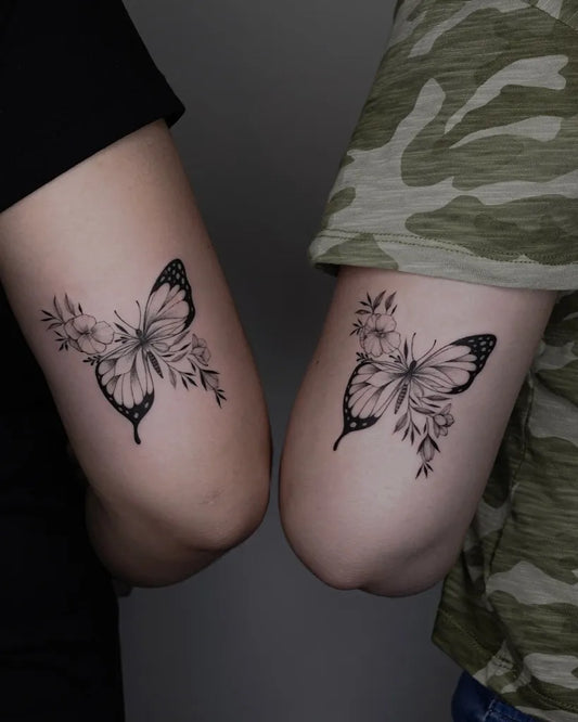 Fine Line Butterfly with Flowers on Women Elbow Tattoo by @uplifttattoo
