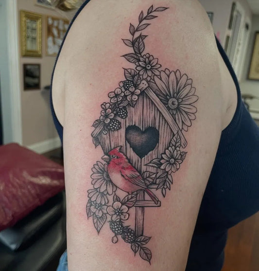 Medium Fine Line Cardinal Birdhouse and Flowers Tattoo on Women Upper Arm by @birdqueendesigns