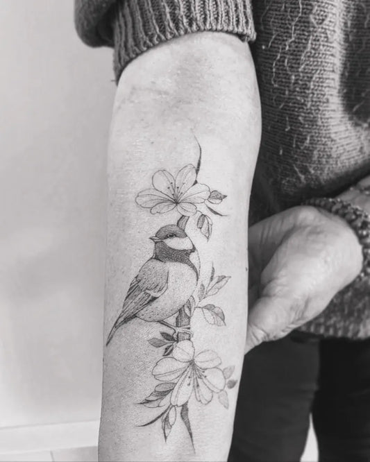 Medium Fine Line Chickadee with Cherry Blossoms Tattoo on Women Arm by @celeno_ttt