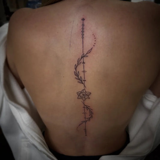 Medium Fine Line Daffodil and Vine Tattoo on Women Back by @boscolaynetattoo