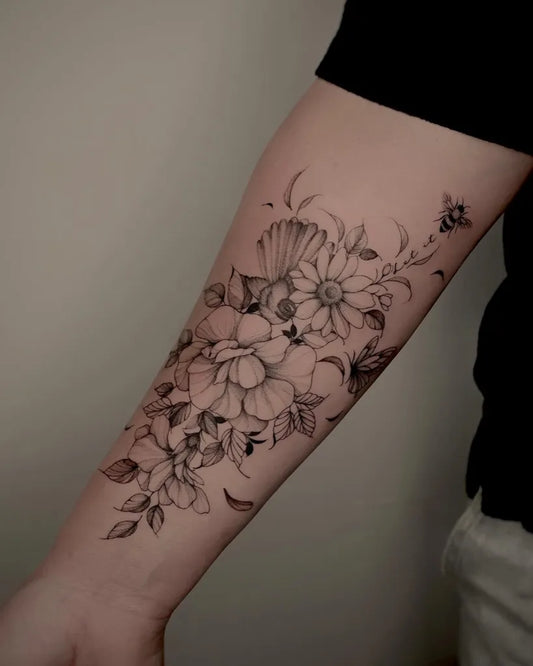 Medium Fine Line Daisy and Seashell Tattoo on Women Arm by @zoe.fineline
