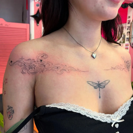 Medium Fine Line Dragonfly Cloud Tattoo on Women Shoulder by @triggerhappytattoos