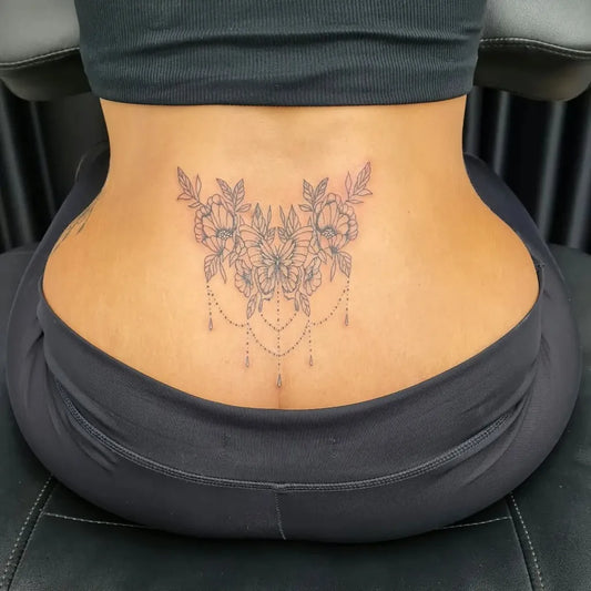 Medium Fine Line Floral Mandala Tattoo on Women Lower Back by @mr.jones.tattoo