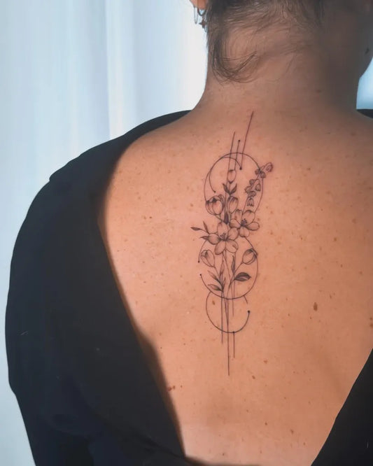 Medium Fine Line Flowers Circles on Women Back Tattoo by @encorps.studio