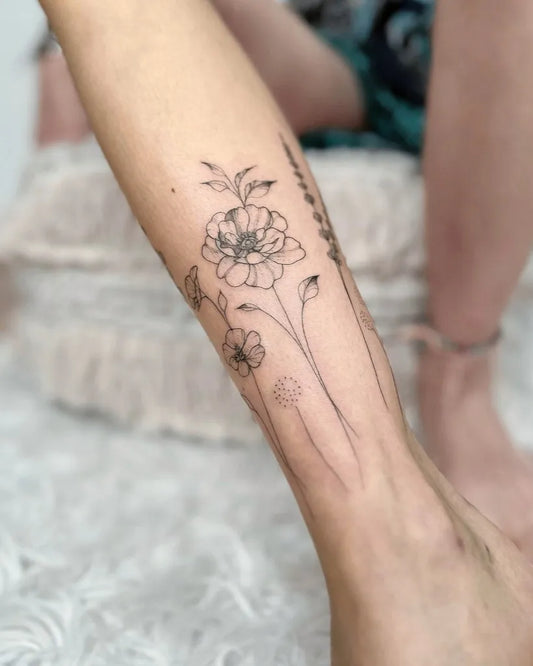 Medium Fine Line Flowers and Stems Tattoo on Women Ankle by @nothingwildtattoo