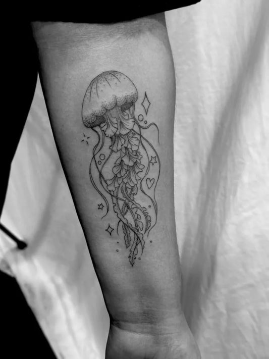 Medium Fine Line Jellyfish Tattoo on Women Arm by @jaycraigtattoos