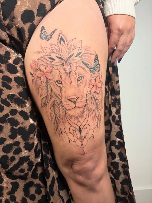 Medium Fine Line Lion with Flowers and Butterflies on Women Thigh Tattoo by @naomiclairetattoo_