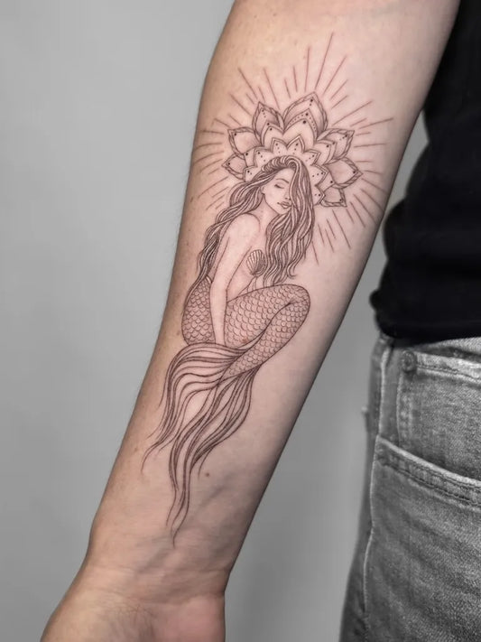 Medium Fine Line Mermaid with Lotus and Sun Tattoo on Women Arm by @who_is_agne