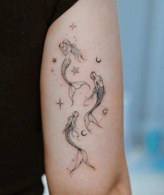 Medium Fine Line Mermaids and Stars Tattoo on Women Arm by @finelinetattoos_page