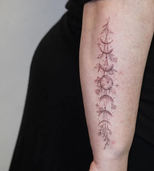 Medium Fine Line Moon Phases and Flowers Tattoo on Women Arm by @ecoart_tattoo