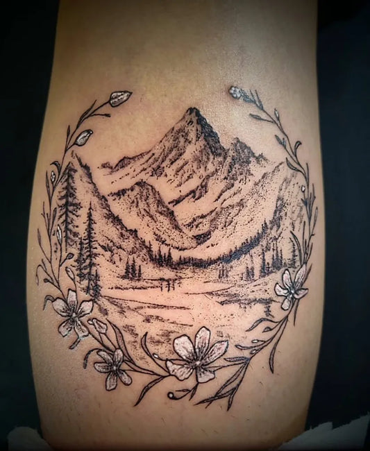 Medium Fine Line Mountain Lake Flowers Nature Tattoo on Women Arm by @anonymousinktattoostudio
