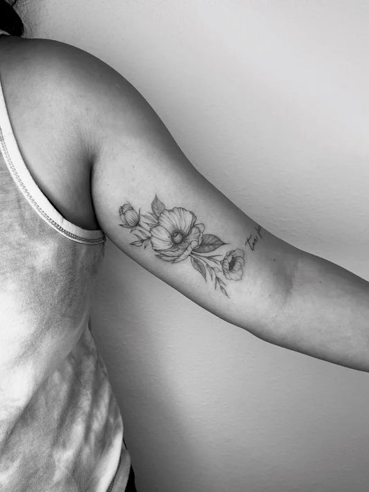 Medium Fine Line Poppy Flowers Tattoo on Women Upper Arm by @ashleylorrainetattoos