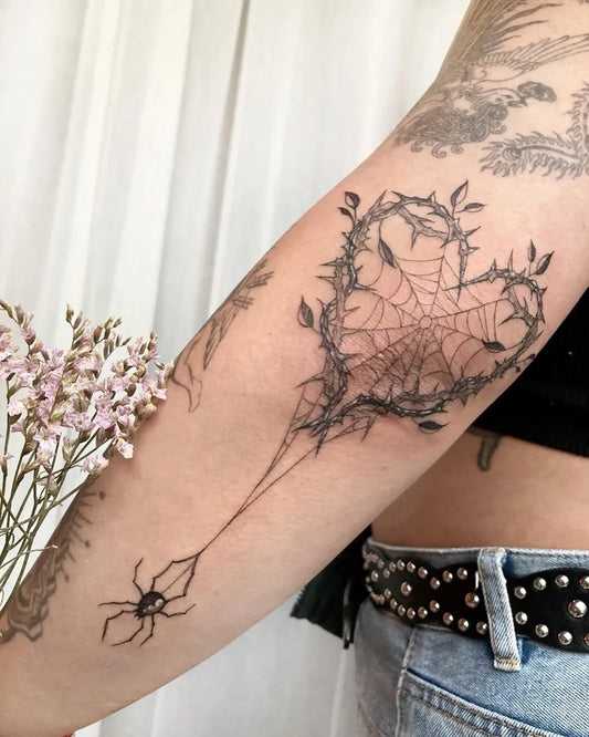 Medium Fine Line Spiderweb and Heart Tattoo on Women Elbow by @velarojatattoo