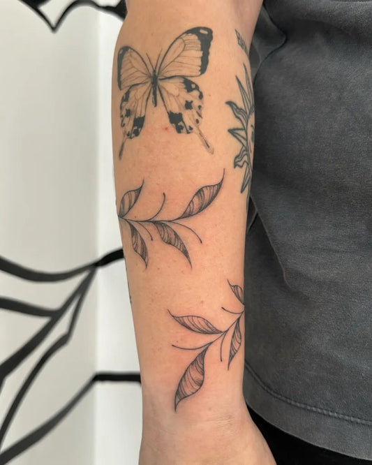 Medium FineLine Butterfly and Leaves on Women Arm Tattoo by @hannlewtattoo