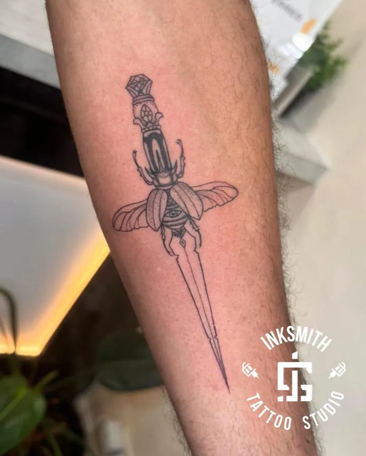 Medium FineLine Dagger with Scarab Beetle on Men Forearm Tattoo by @inksmithtattoobda