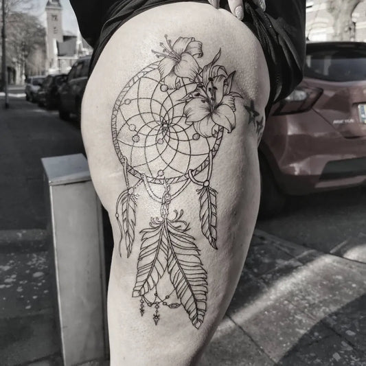 Medium FineLine Dream Catcher with Hibiscus Tattoo on Women Thigh by @_tiny_ink