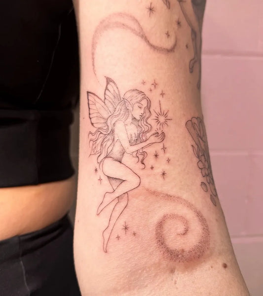 Medium FineLine Fairy with Stars and Swirls on Women Arm Tattoo by @pinkcosmetictattoo