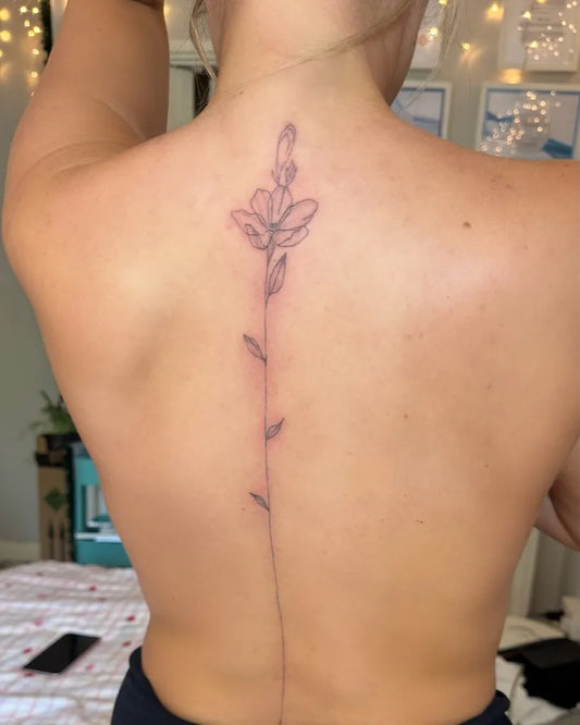 Medium FineLine FlowerStem on Women Back Tattoo by @ciaobella_beautyse16