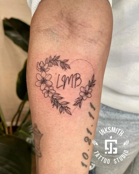 Medium FineLine HeartWithLMBAndFlowers on Women Arm Tattoo by @inksmithtattoobda