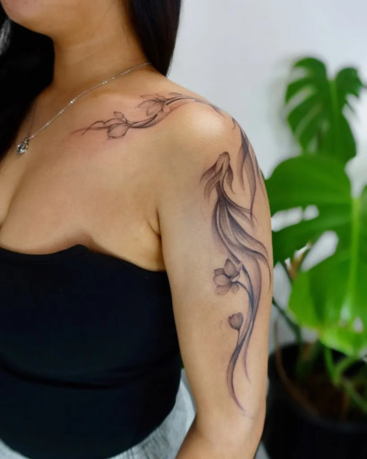 Medium FineLine Phoenix and Lotus on Women Shoulder Tattoo by @minaa.ink