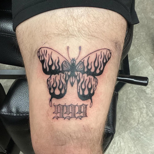 Medium Flaming Butterfly with Flames and 999 Tattoo on Men Thigh by @tattoos4breakfast
