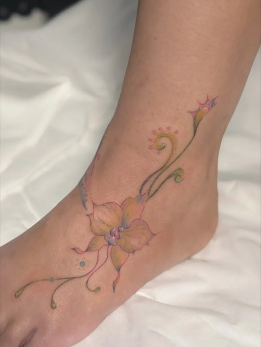 Medium Floral Orchid and Vines Tattoo on Women Foot by @dreamhandstattoostudio