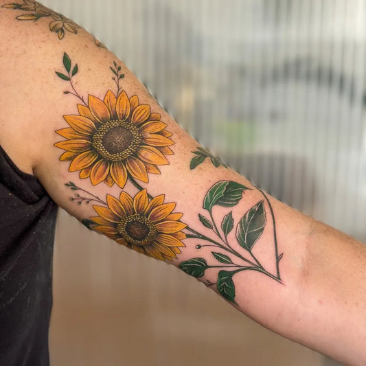 Medium Floral Sunflowers and Leaves on Women Arm Tattoo by @sarah.opuntia.tattoo