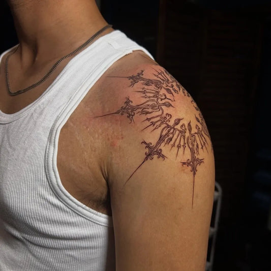 Medium Gothic Sun with Spikes Tattoo on Men Shoulder by @oak_tattoo_studio