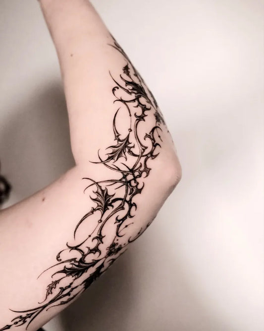 Medium Gothic Tribal Vines Tattoo on Women Arm by @auua.tattoo