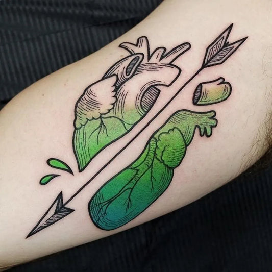 Medium Illustrative Arrow Heart Tattoo on Men Arm by @tattoosnob