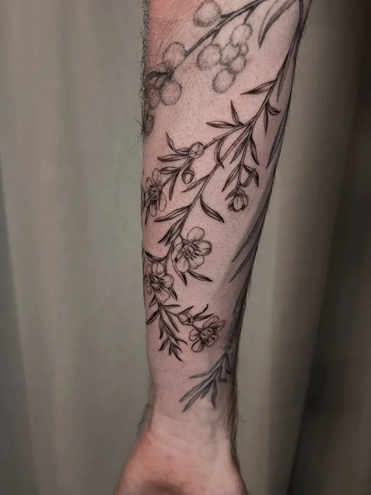 Medium Illustrative Botanical Branch with Flowers Tattoo on Men Arm by @raecolliertattoo