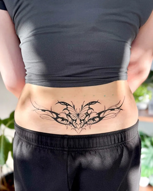 Medium Illustrative Butterfly and Spines Tattoo on Women Lower Back by @dontsleepvincci