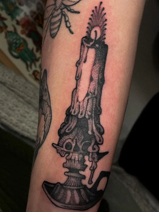 Medium Illustrative Candle with Skull Tattoo on Men Arm by @tinyloophole