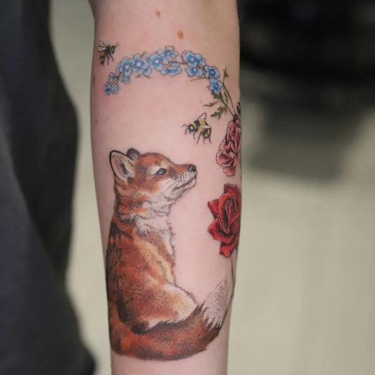 Medium Illustrative Fox Bees and Roses Tattoo on Women Arm by @tattoo.trish