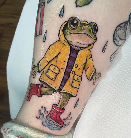 Medium Illustrative Frog in Raincoat Tattoo on Women Arm by @justmeganlee