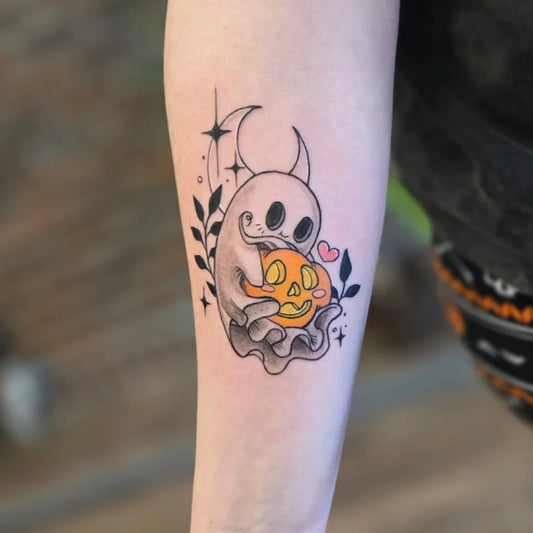 Medium Illustrative Ghost Holding Pumpkin Tattoo on Women Arm by @tama.inks