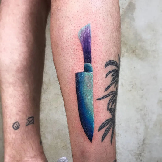 Medium Illustrative Knife with Palm Leaf Tattoo on Men Leg by @valeriatattooing