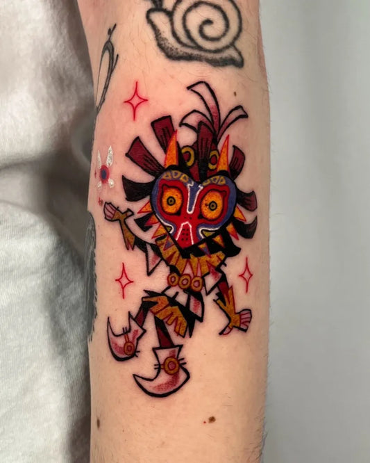 Medium Illustrative Majora Mask Tattoo on Women Arm by @shlorp.tats
