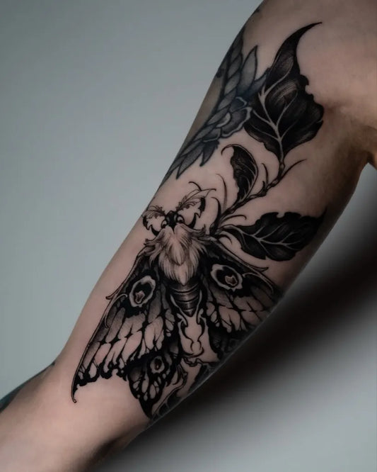 Medium Illustrative Moth and Leaves Tattoo on Women Arm by @_laurafey_