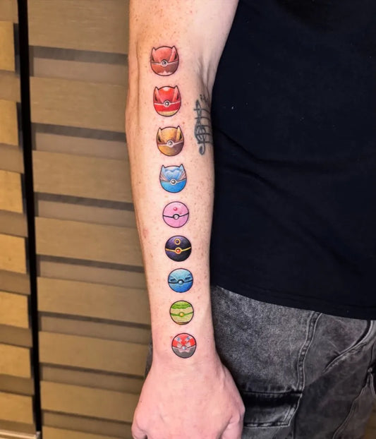 Medium Illustrative Pokemon Balls Tattoo on Men Arm by @pigmentedtattoos
