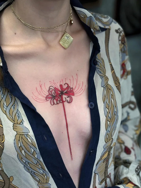 Medium Illustrative Red Spider Lily Tattoo on Women Sternum by @inked_frogs