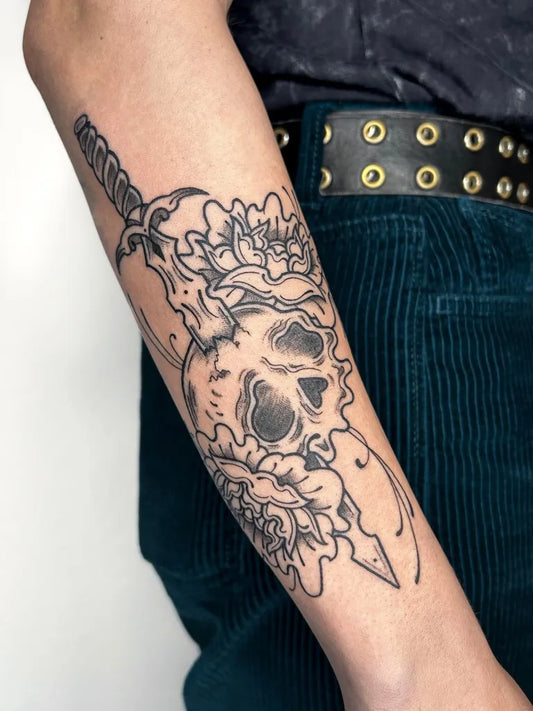 Medium Illustrative Skull Sword Flowers Tattoo on Women Arm by @traumstolz